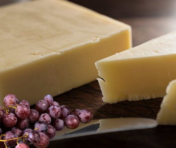 A block of cheddar cheese, showcasing its creamy texture and sharp, tangy flavour.